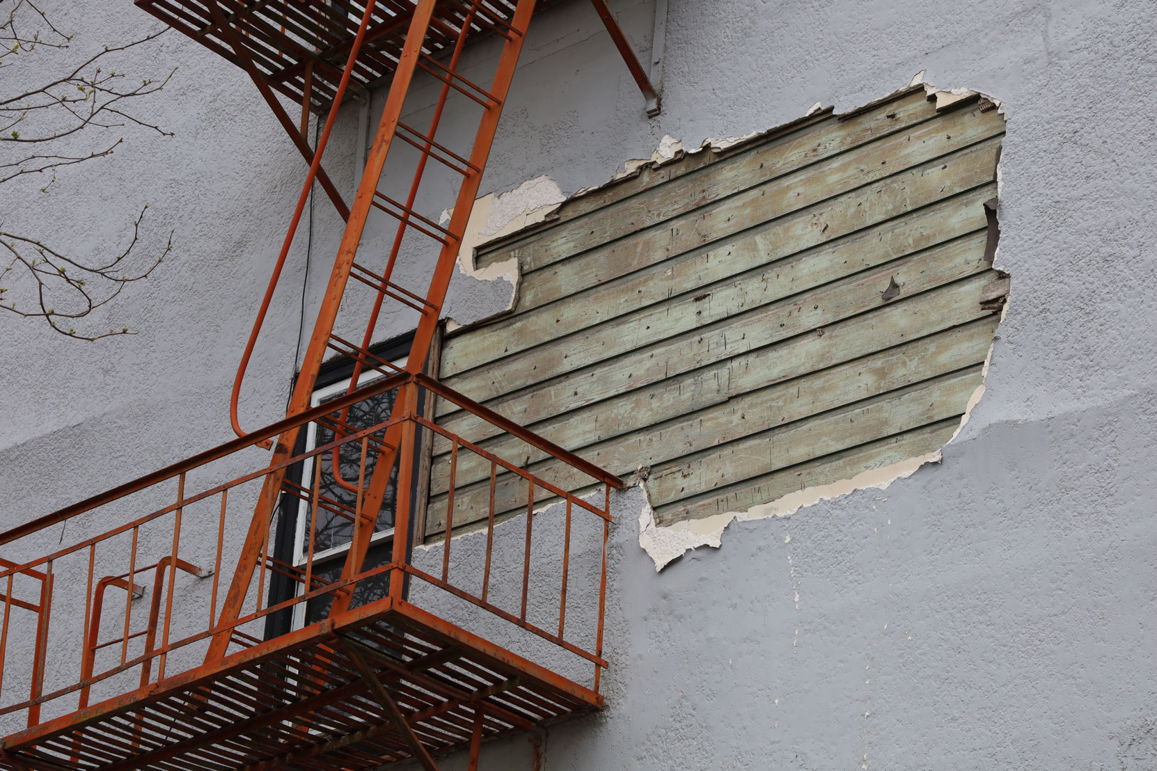The north wall of the Ladysmith Inn, 640 1st Avenue in downtown Ladysmith, B.C., April 2020, showing part of the original wood wall under the current exterior.